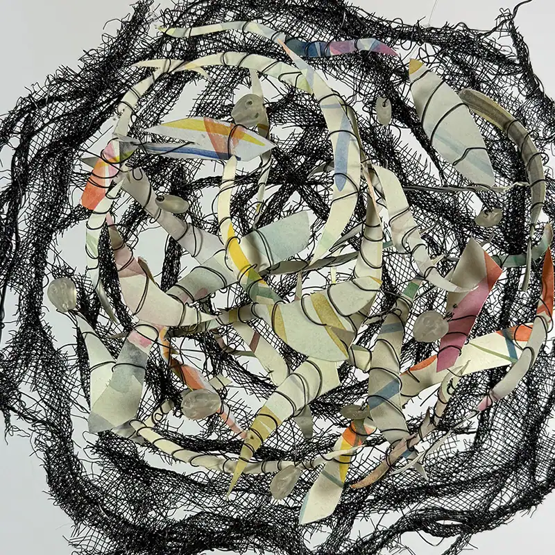 Nest-shaped mixed media art piece with paper with watercolor, beads, screen, and wire elements.